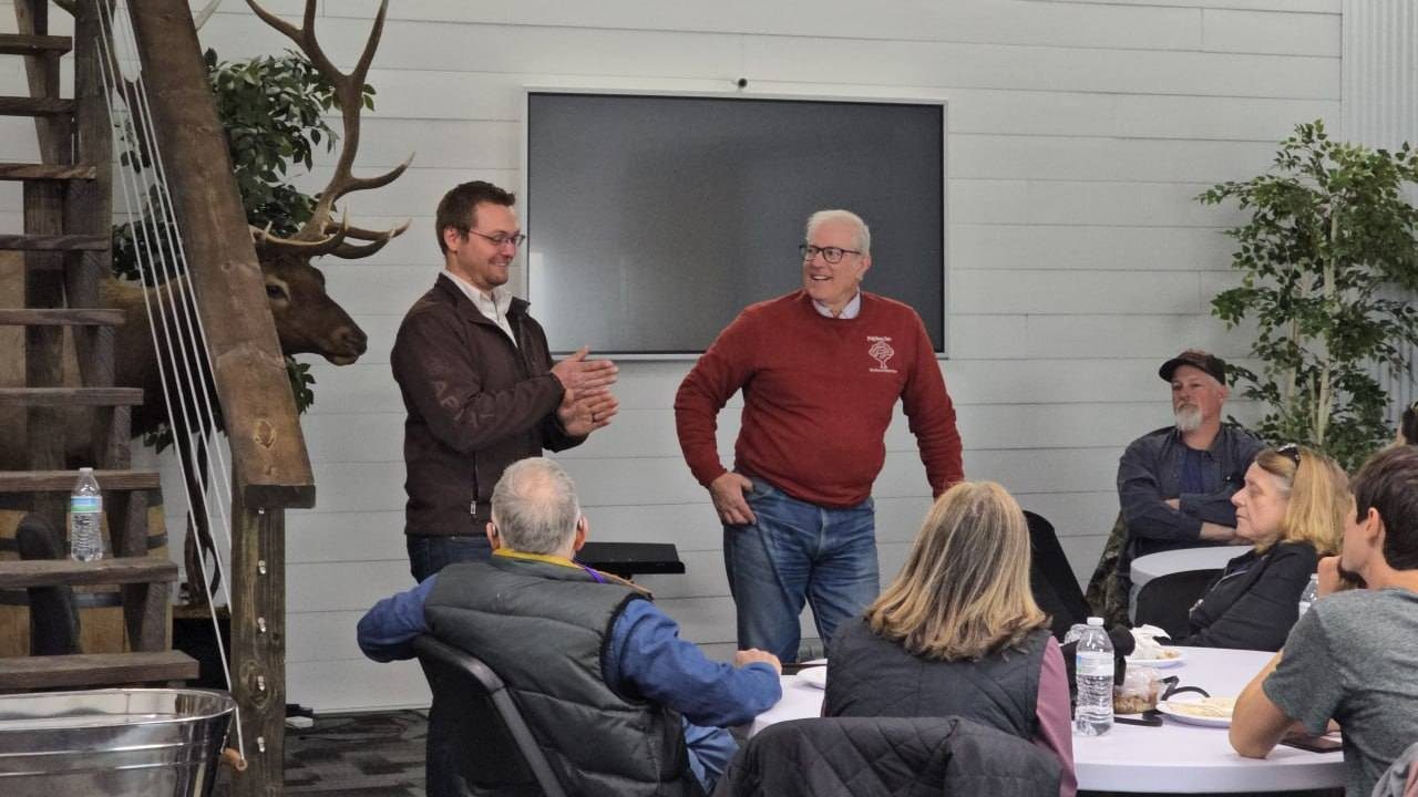 Jamon Mysliwiec on stage with Joel Salatin